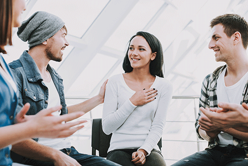 group of young men and women participating in a therapy session at a cocaine addiction center group meeting