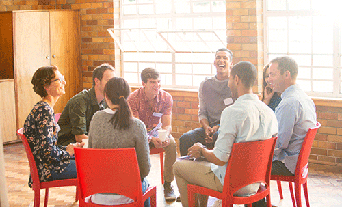 men and women sitting together in a circle as part of a group session at a fentanyl addiction treatment center