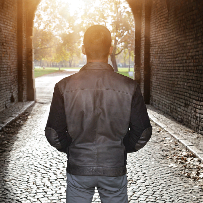 image of young man from behind as he walks down cobblestone road into the sunset and wonders how is cocaine addiction treated