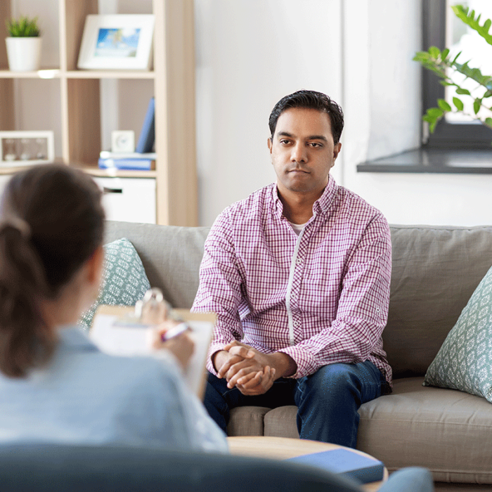 young man seated in therapist's office and asking where can I find cocaine addiction treatment in Hudson, OH?