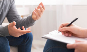 A client talks to his provider while receiving medication-assisted treatment in outpatient rehab.