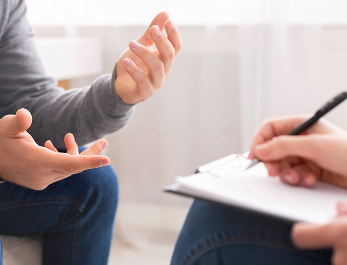 A client talks to his provider while receiving medication-assisted treatment in outpatient rehab.