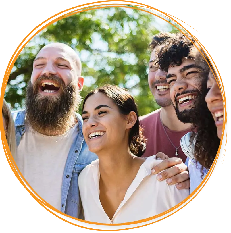 A group of smiling, laughing people standing side-by-side outside at a reputable drug rehab in Akron, OH.